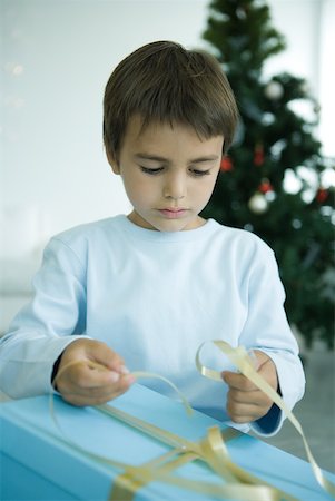 Boy opening Christmas present Stock Photo - Premium Royalty-Free, Code: 632-01380647