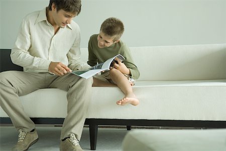 Father and son reading magazine together Stock Photo - Premium Royalty-Free, Code: 632-01380667