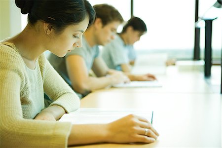 simsearch:695-05763398,k - College students sitting at table, studying Stock Photo - Premium Royalty-Free, Code: 632-01380705