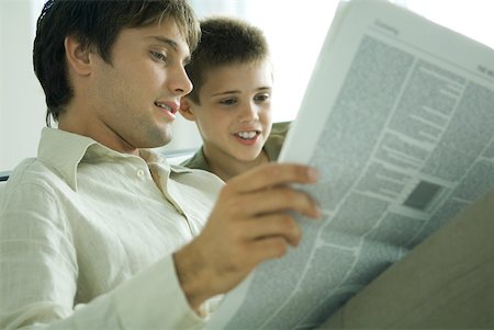 simsearch:696-03401226,k - Father and son reading newspaper together Stock Photo - Premium Royalty-Free, Code: 632-01380701