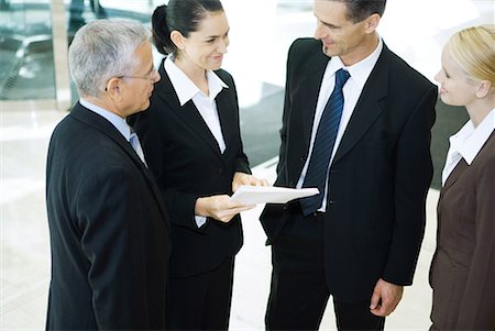 simsearch:649-05657044,k - Business associates standing together, smiling, high angle view Stock Photo - Premium Royalty-Free, Code: 632-01612024