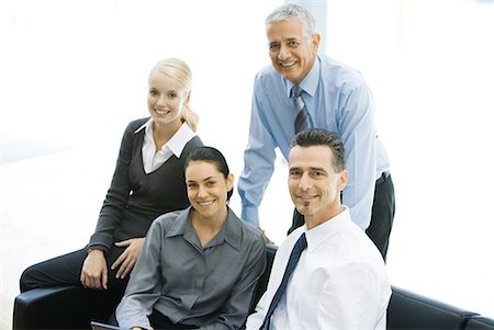 Four business associates smiling at camera, group portrait Stock Photo - Premium Royalty-Free, Code: 632-01612051