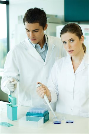 scientists standing together - Male and female lab workers standing side by side, woman looking at camera Stock Photo - Premium Royalty-Free, Code: 632-01612765