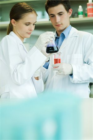 scientists standing together - Young male and female lab workers, holding lab glassware Stock Photo - Premium Royalty-Free, Code: 632-01612766