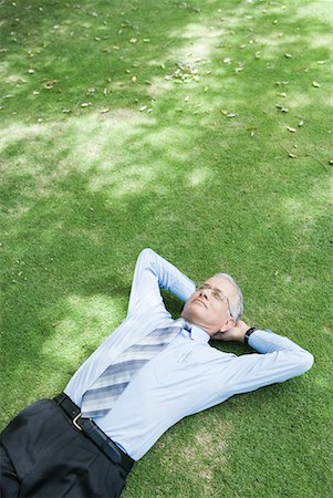 person lying on back hands behind head - Businessman lying on grass with hands behind head Stock Photo - Premium Royalty-Free, Code: 632-01612907