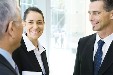 simsearch:695-03376535,k - Three business associates talking, smiling Stock Photo - Premium Royalty-Free, Code: 632-01612902