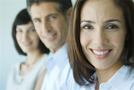 simsearch:695-03376535,k - Businesswoman smiling at camera, portrait, business associates in background Stock Photo - Premium Royalty-Free, Code: 632-01613114