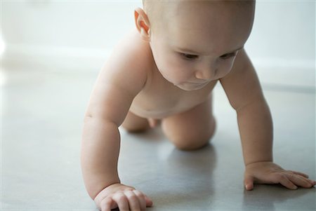 person on all four - Naked baby crawling on floor, three quarter length Stock Photo - Premium Royalty-Free, Code: 632-01613260