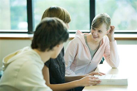 Three students sitting at table, chatting Stock Photo - Premium Royalty-Free, Code: 632-01613427