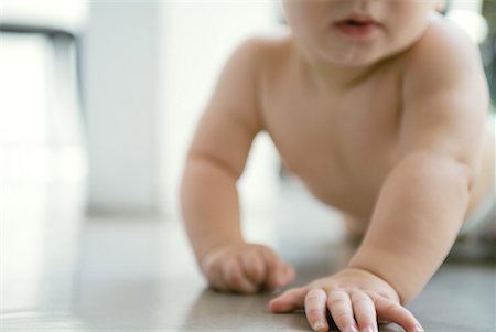 person on all four - Baby crawling on floor, cropped view Stock Photo - Premium Royalty-Free, Code: 632-01636909