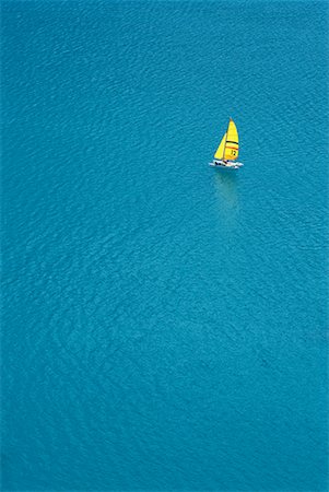 simsearch:632-01234708,k - Trimaran sailing in blue sea, aerial view Foto de stock - Sin royalties Premium, Código: 632-01638112