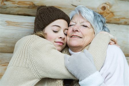 senior cabin - Grandmother and granddaughter embracing, eyes closed, portrait Stock Photo - Premium Royalty-Free, Code: 632-01638455