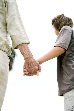 simsearch:632-05401213,k - Senior woman and grandson holding hands, cropped, low angle view Fotografie stock - Premium Royalty-Free, Codice: 632-01638744