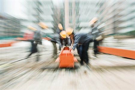simsearch:632-01784566,k - Workers at construction site, blurred motion Fotografie stock - Premium Royalty-Free, Codice: 632-01784543