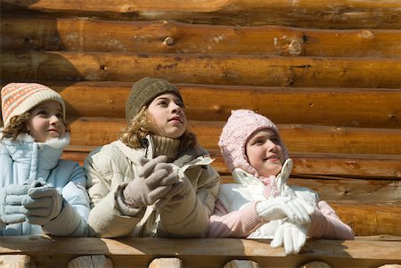 family in log cabin - Three preteen or teen girls standing on deck of log cabin, looking away, low angle view Stock Photo - Premium Royalty-Free, Code: 632-01785035