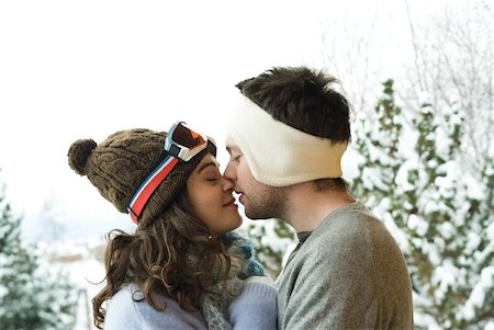 simsearch:632-03779625,k - Young couple in winter clothes, kissing, side view Stock Photo - Premium Royalty-Free, Code: 632-01785038
