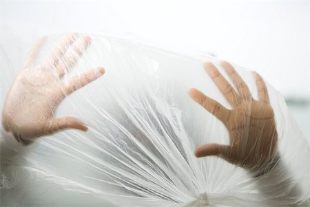 Hands inside plastic bag, cropped view Stock Photo - Premium Royalty-Free, Code: 632-01785229