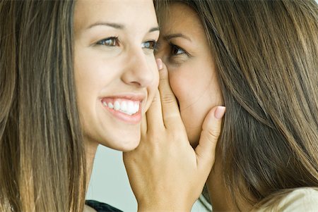 female teen twins - Teenage girl whispering in twin sister's ear, close-up Stock Photo - Premium Royalty-Free, Code: 632-01785324