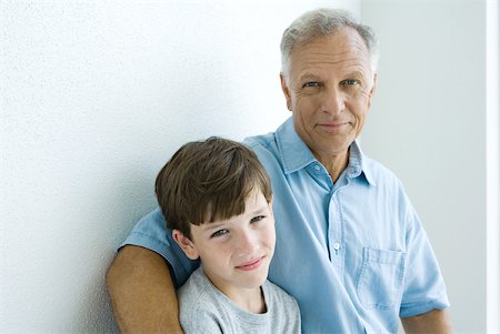 Grandfather and grandson smiling at camera together, portrait Stock Photo - Premium Royalty-Free, Code: 632-01828631
