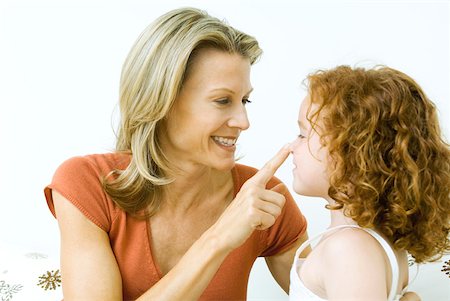 fingering mom photo - Woman touching daughter's nose, both smiling Stock Photo - Premium Royalty-Free, Code: 632-02006906