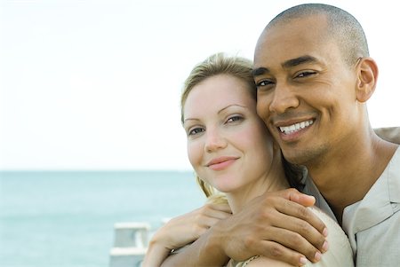 simsearch:696-03402108,k - Couple embracing outdoors, smiling at camera together Stock Photo - Premium Royalty-Free, Code: 632-02006918