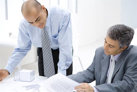 Two businessmen looking over documents together Stock Photo - Premium Royalty-Free, Code: 632-02008133