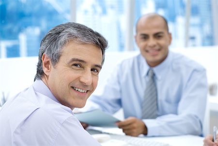 simsearch:632-02345008,k - Two businessmen in office, smiling at camera Stock Photo - Premium Royalty-Free, Code: 632-02008150