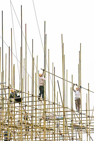 scaffold - Construction workers on scaffolding, low angle view Stock Photo - Premium Royalty-Free, Code: 632-02038732