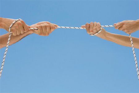 simsearch:633-02645515,k - Hands playing tug-of-war with rope Stock Photo - Premium Royalty-Free, Code: 632-02128118