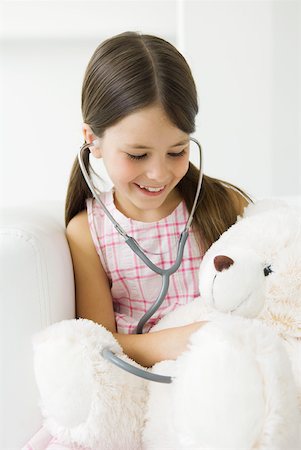 people sitting alone girl with teddy bear - Girl listening to teddy's bear's heart with stethoscope Stock Photo - Premium Royalty-Free, Code: 632-02227643