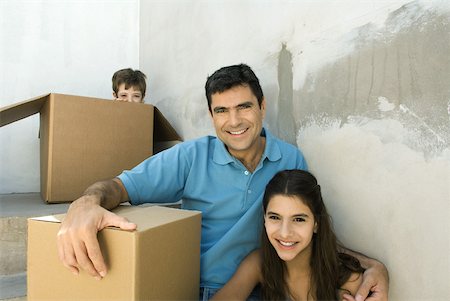 simsearch:695-03379156,k - Family sitting on stairwell with cardboard boxes, boy hiding Stock Photo - Premium Royalty-Free, Code: 632-02227770
