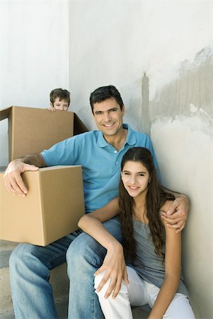 simsearch:695-03379156,k - Father and teen daughter on stairwell with cardboard boxes, boy hiding in background Stock Photo - Premium Royalty-Free, Code: 632-02227781