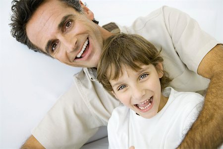 Father with arm wrapped around son, both smiling at camera, portrait Stock Photo - Premium Royalty-Free, Code: 632-02227824