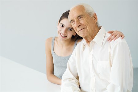 simsearch:695-03377503,k - Teenage girl with arm around her grandfather's shoulder, senior man looking away Stock Photo - Premium Royalty-Free, Code: 632-02227934