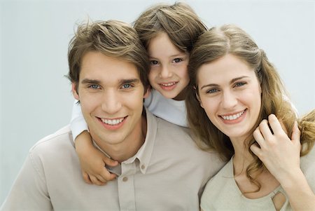 simsearch:632-02416107,k - Little boy putting his arms around the shoulders of his parents, smiling at camera, portrait Stock Photo - Premium Royalty-Free, Code: 632-02227955