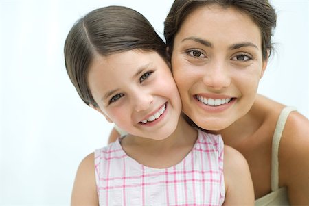 simsearch:632-02416107,k - Mother and daughter cheek to cheek, both smiling at camera Stock Photo - Premium Royalty-Free, Code: 632-02227962