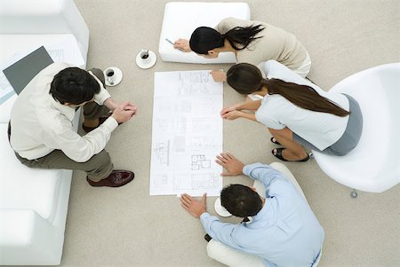 professional future - Team of professionals looking at blueprint together, overhead view Stock Photo - Premium Royalty-Free, Code: 632-02282394