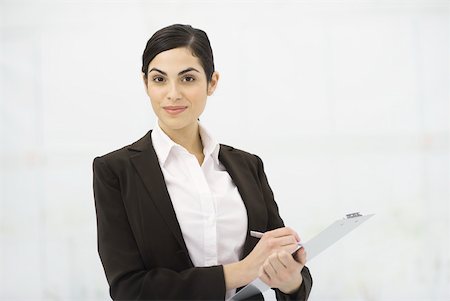 simsearch:632-03027019,k - Businesswoman holding clipboard, taking notes, smiling at camera, portrait Stock Photo - Premium Royalty-Free, Code: 632-02282831