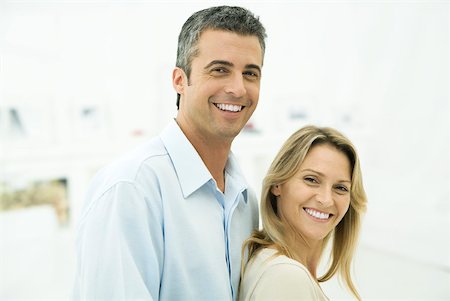 simsearch:632-02345008,k - Couple smiling at camera, woman leaning against man, portrait Stock Photo - Premium Royalty-Free, Code: 632-02344975