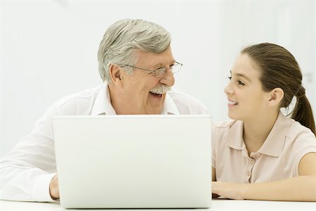 person and lap top and cut out - Grandfather and granddaughter sitting with laptop, laughing Stock Photo - Premium Royalty-Free, Code: 632-02344986