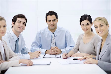simsearch:632-03779792,k - Businessman sitting with colleagues at conference table, smiling at camera Stock Photo - Premium Royalty-Free, Code: 632-02345090