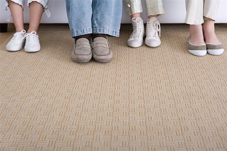 feet on sofa - Four pairs of feet wearing different styles of shoes Stock Photo - Premium Royalty-Free, Code: 632-02345187