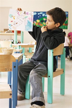 elementary drawing pictures - Boy holding up drawing in class room Stock Photo - Premium Royalty-Free, Code: 632-02690156