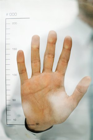 Man holding hand up to ruler Stock Photo - Premium Royalty-Free, Code: 632-02690227
