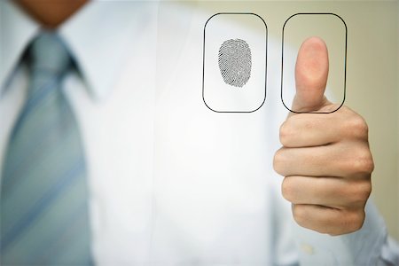 pollice - Man pressing thumb to fingerprint reader Fotografie stock - Premium Royalty-Free, Codice: 632-02690221