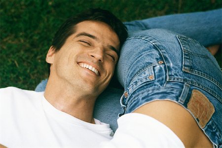 Man resting head on woman's legs, laughing, cropped Stock Photo - Premium Royalty-Free, Code: 632-02744793