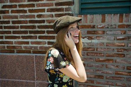 Young woman wearing trendy hat and talking on cell phone Stock Photo - Premium Royalty-Free, Code: 632-02744988