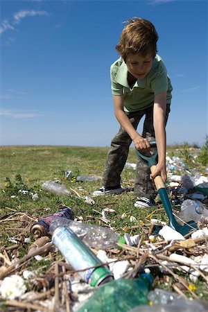 simsearch:632-02745049,k - Boy shoveling trash in field Stock Photo - Premium Royalty-Free, Code: 632-02745084