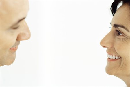 side profile face smile - Husband and wife smiling at each other, cropped Stock Photo - Premium Royalty-Free, Code: 632-02745118