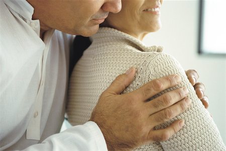devoted - Husband embracing wife from behind, cropped Stock Photo - Premium Royalty-Free, Code: 632-02745155